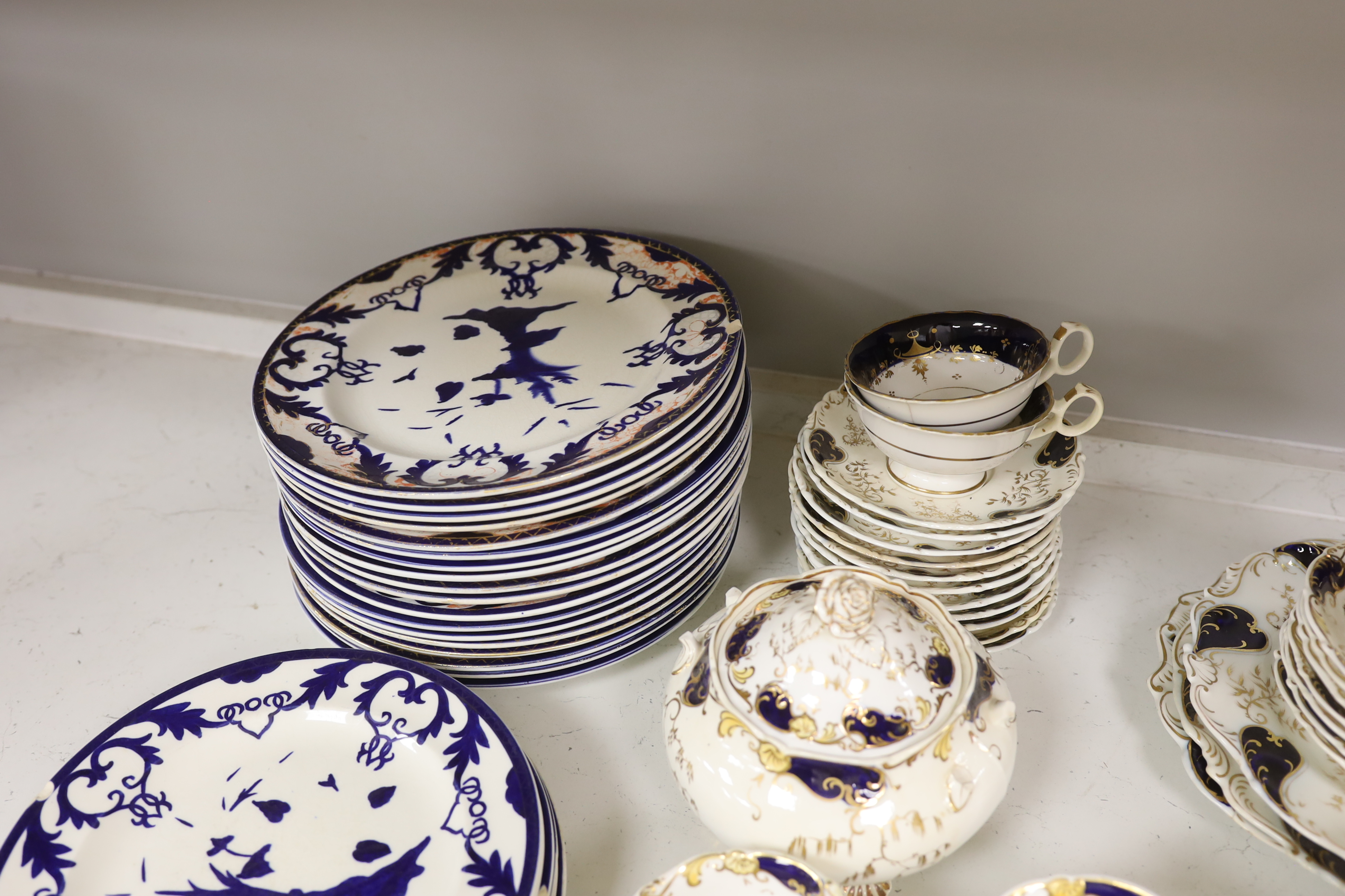 A Royal Crown Derby blue and gilt bordered part dessert service, together with a Victorian Staffordshire blue and gilt part tea service